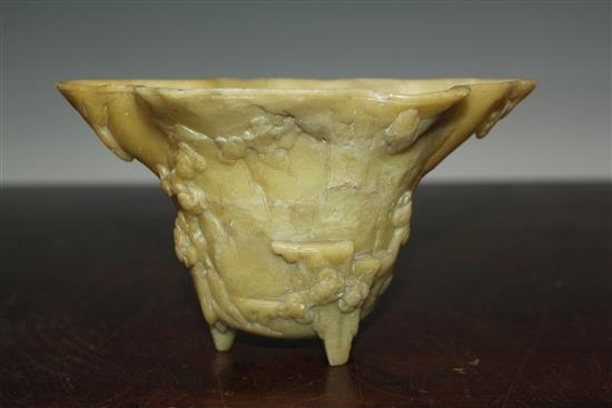 A Chinese pale green soapstone libation cup, 19th century, width 18.5cm, height 10cm, faults